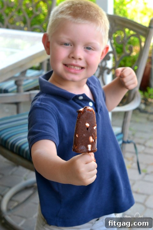 Popsicle molds filled with the creamy Rocky Road Pudding mixture, ready to be frozen.