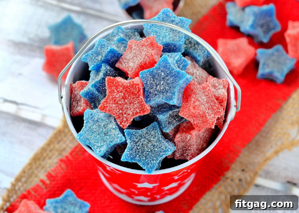 Wide shot of homemade gumdrops cut into star shapes. Made with red and blue jello. 