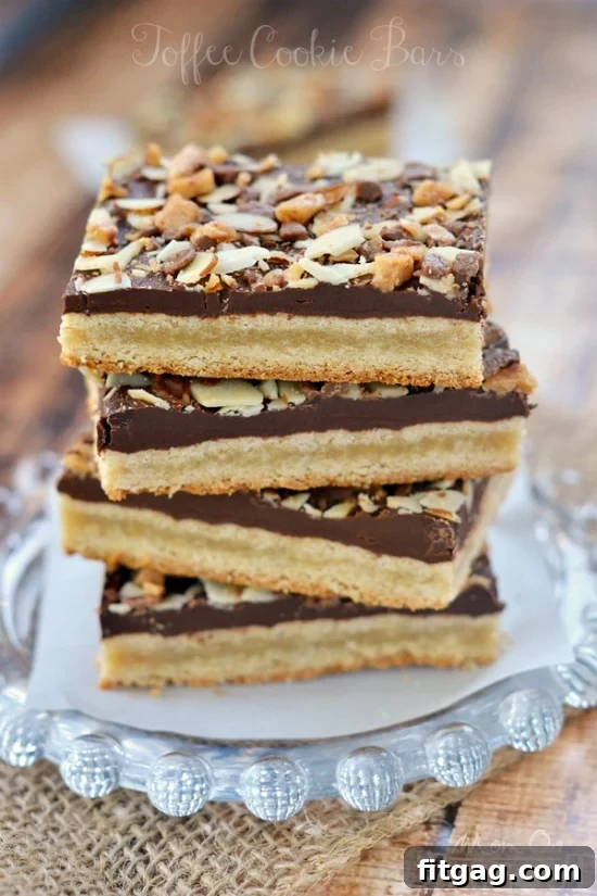 Buttery Toffee Blondies 2 A top-down view of freshly baked Toffee Cookie Bars, showcasing the rich chocolate layer, crunchy almonds, and golden toffee bits on a soft cookie base.