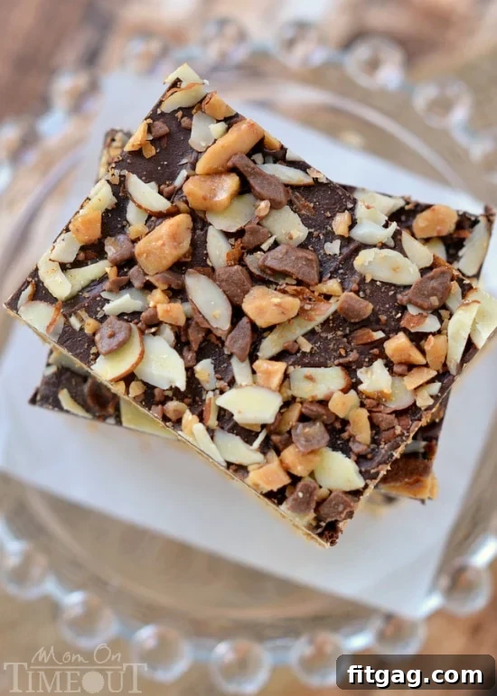 Buttery Toffee Blondies 3 Close-up shot of a single Toffee Cookie Bar, highlighting the smooth chocolate topping, scattered almonds, and amber toffee pieces.