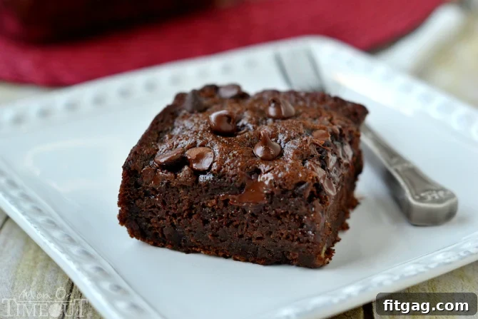 A freshly baked Chocolate Banana Applesauce Cake, ready for slicing. A guilt-free dessert option.