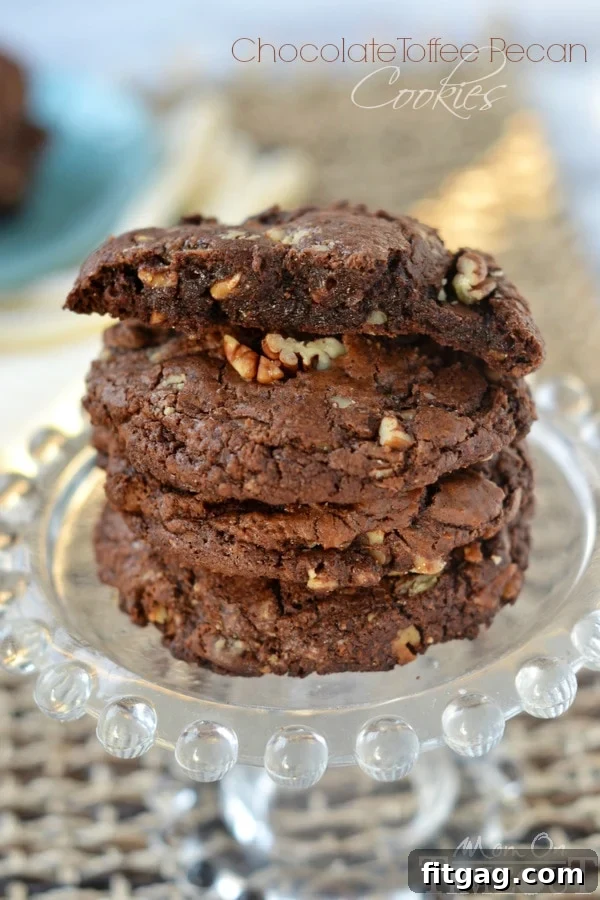 Unbelievably rich and fudgy, these bakery-style Chocolate Toffee Pecan Cookies are a chocolate lover's dream! | MomOnTimeout.com
