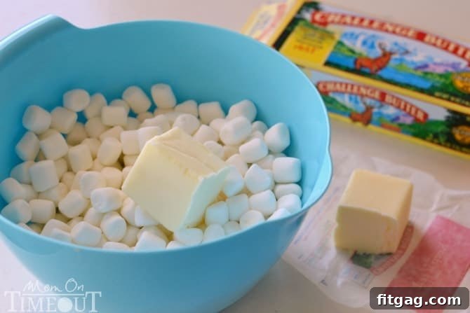 Mixing melted butter and marshmallows with Rice Krispies cereal and graham cracker crumbs for the pinwheel base.