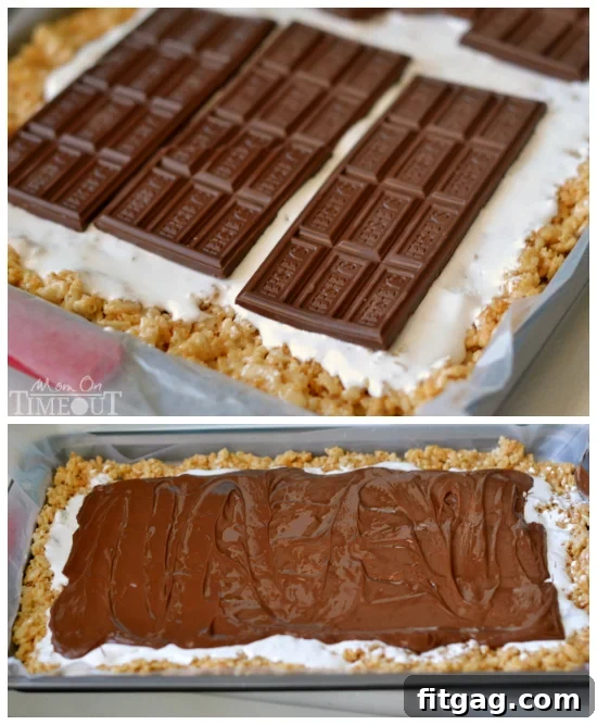 Spreading melted Hershey's chocolate bars over a layer of marshmallow creme on the Rice Krispies base.