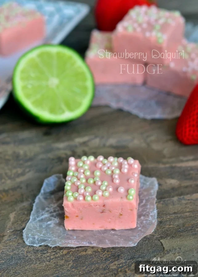 Close-up of freshly made Strawberry Daiquiri Fudge squares, showcasing the creamy texture and lime zest speckles.