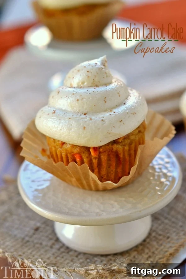 Delicious Pumpkin Carrot Cake Cupcakes with a swirl of Maple Cream Cheese Frosting, a perfect fall dessert.