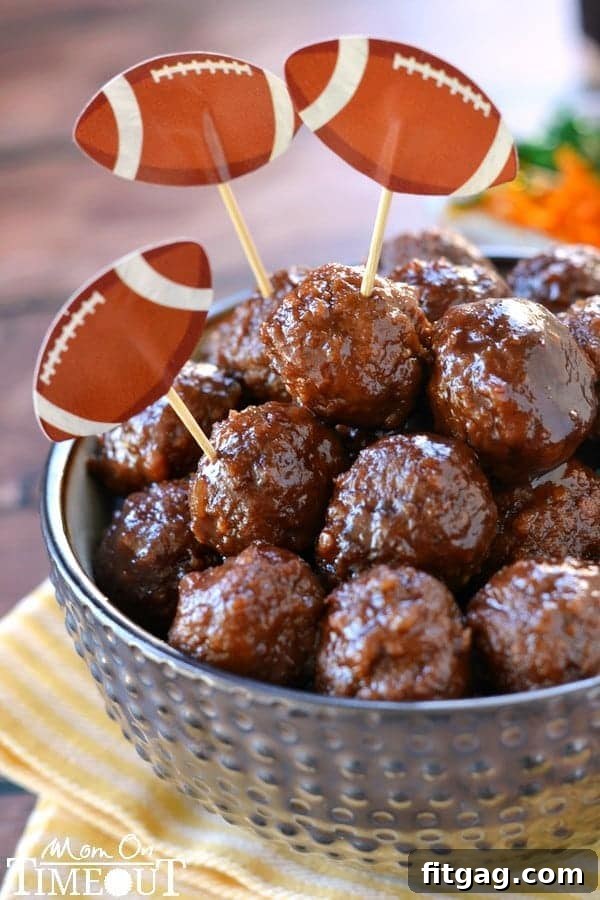Crock-Pot Party Meatball Bites 4 Game day cocktail meatballs served with festive football-themed toothpicks, perfect for a gathering.