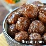 Cooked cocktail meatballs with sauce.