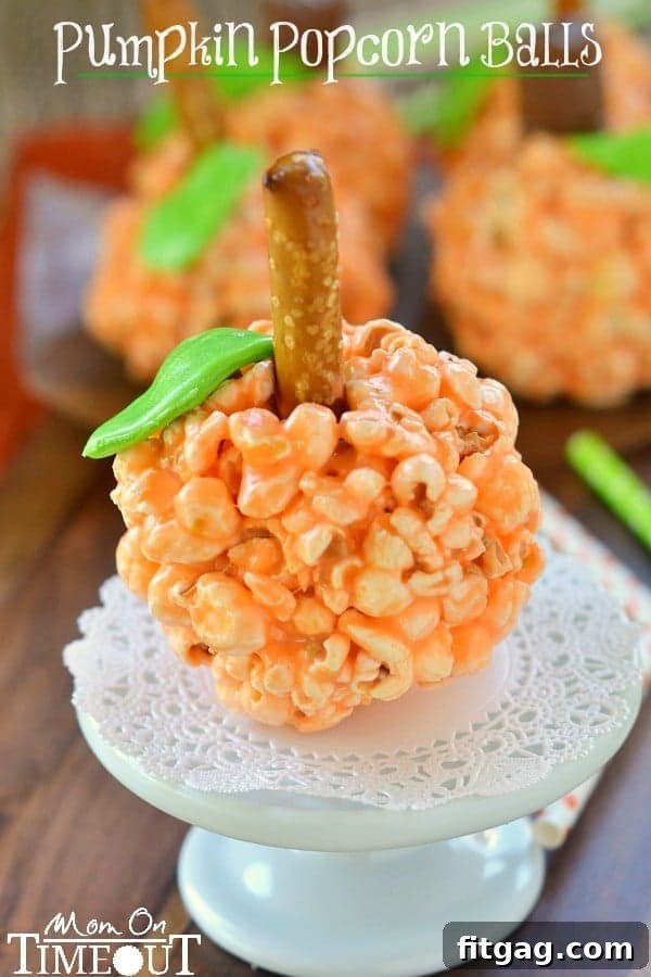 Autumn Pumpkin Popcorn Bites 2 Delightful and chewy Pumpkin Popcorn Balls, made with marshmallows, perfect for Halloween and Thanksgiving celebrations.