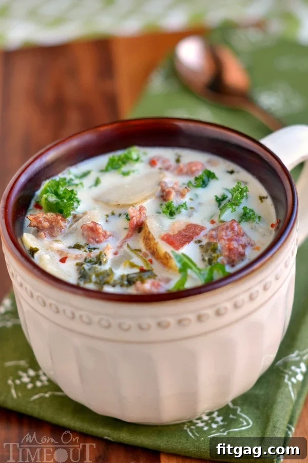 Hearty Slow Cooker Zuppa Toscana 4 A bowl of creamy Crockpot Zuppa Toscana soup, topped with Parmesan cheese and fresh parsley.