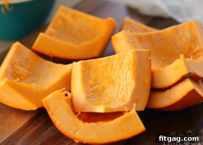 Pumpkin cut into small, manageable pieces, suitable for placement and even cooking in a slow cooker to make homemade puree.