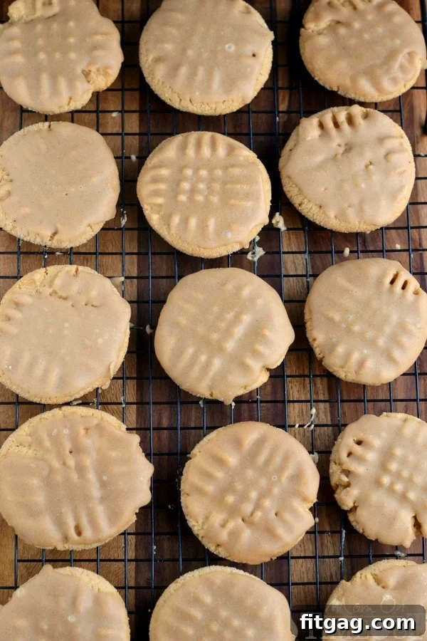 Maple cinnamon glazed peanut butter cookies cooling on a wire rack, showing the glistening glaze