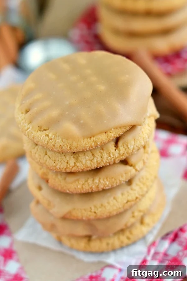 Close-up shot of a maple cinnamon glazed peanut butter cookie, highlighting its moist texture and rich glaze