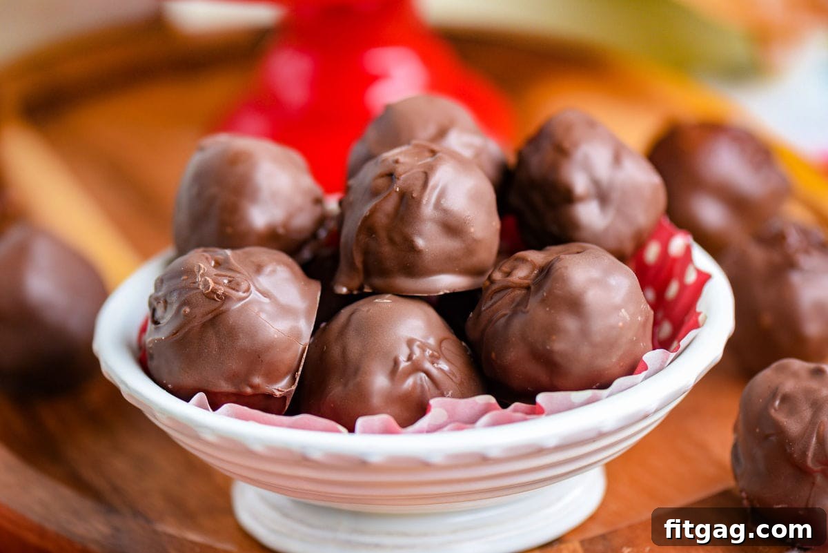 First Lady's Coconut Delights 4 A white bowl filled with finished Martha Washington Candies, each perfectly coated in chocolate, ready for serving.