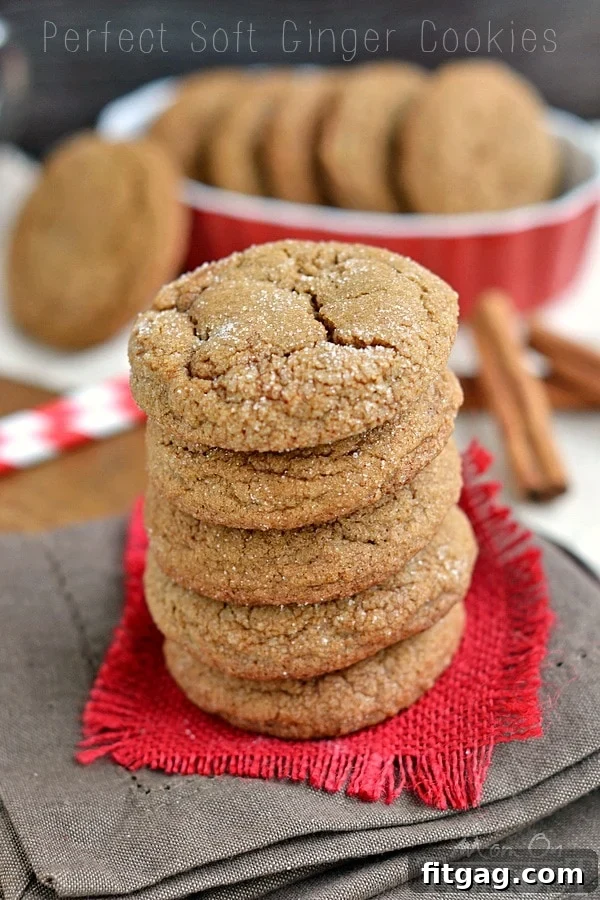 Stacked ginger molasses cookies with a crisp sugar coating, ready for the holidays.