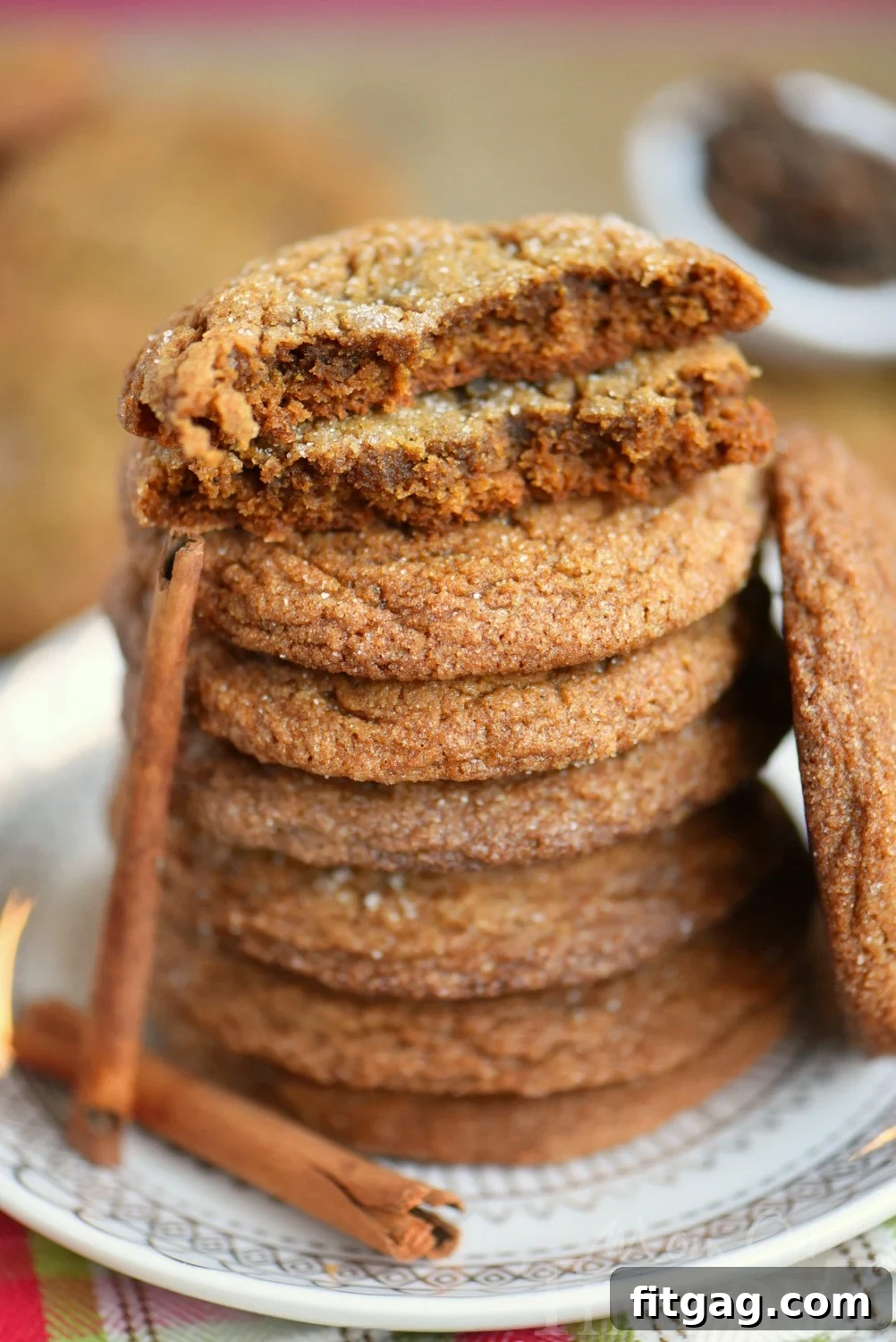 Close-up of baked ginger molasses cookies showcasing the rich color and spice details.