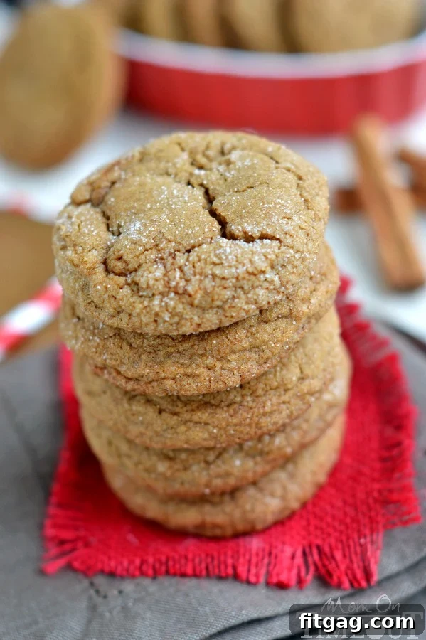 Perfectly baked ginger cookies coated in sugar, displaying beautiful cracked tops.