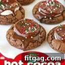 hot cocoa cookies on white plate with christmas sprinkles on top and title overlay at bottom