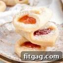 three kolackzi cookies stacked on each other on two gold rimmed plates.
