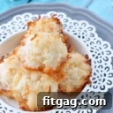 coconut macaroons on white plate with blue background