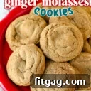 Chewy ginger molasses cookies piled high on a red plate.