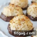 coconut macaroons dipped in chocolate on white cake stand