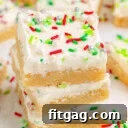 Three Christmas Sugar Cookie Bars in a stack with more bars in the background.