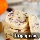shortbread cookies stacked on white plate with one cookie leaning against the stack