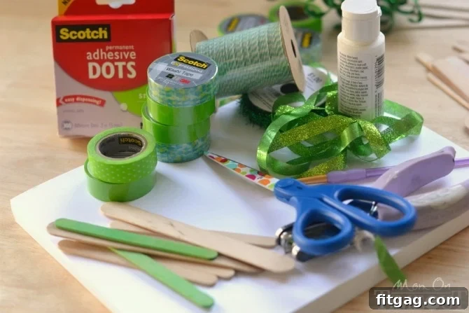 Crafting supplies neatly arranged: washi tape, cardstock, scissors, adhesive dots, twine, hole punch, and popsicle sticks.