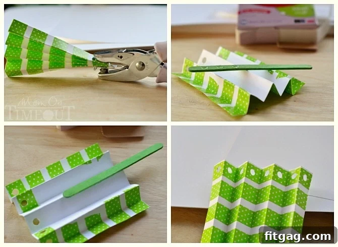 A craft image illustrating the accordion-folded paper with a punched hole, ready for the popsicle stick 'trunk'.