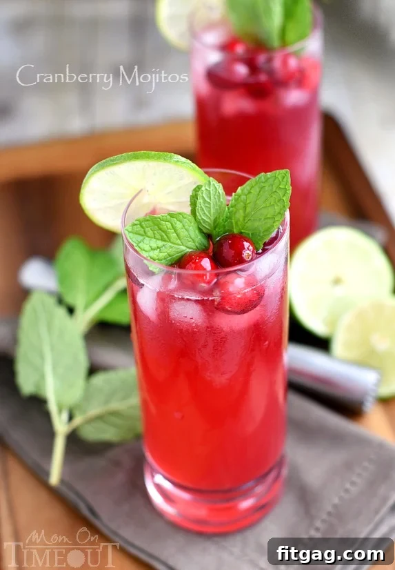 Cranberry Mojitos are perfect for any night but especially a celebration! Tart, sweet, refreshing, and delicious - everything a good cocktail should be. | MomOnTimeout.com | #cocktail #cranberry #beverage #recipe
