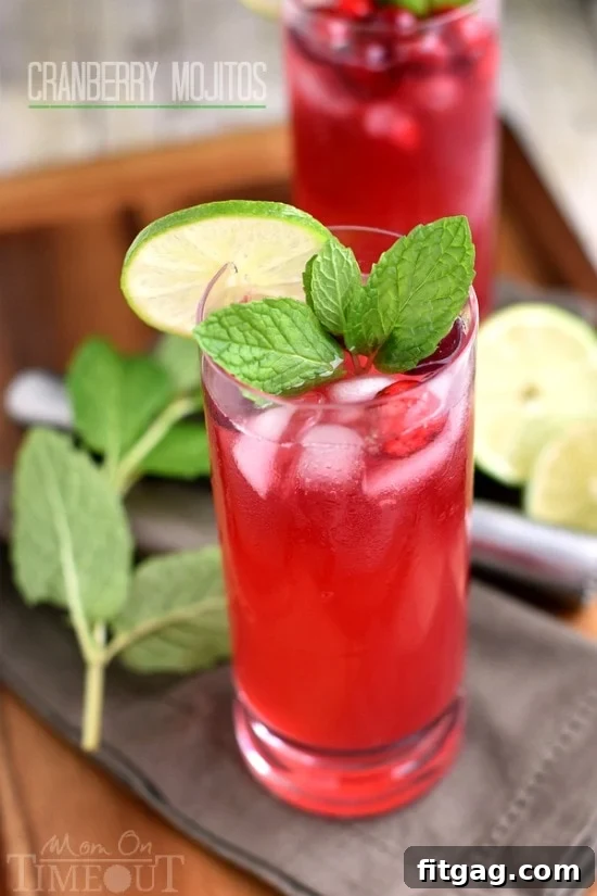 Cranberry Mojitos are perfect for any night but especially a celebration! Tart, sweet, refreshing, and delicious - everything a good cocktail should be. | MomOnTimeout.com | #cocktail #cranberry #beverage #recipe