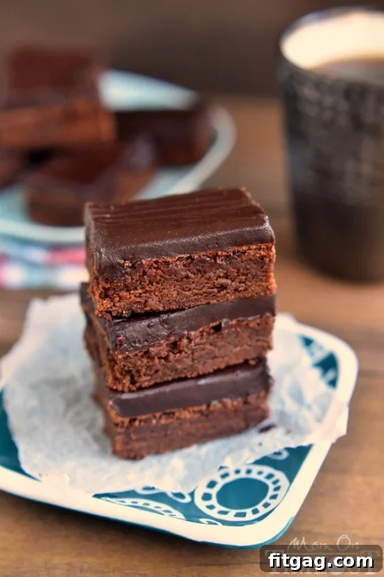 Velvet Mocha Truffle Brownies 4 Close-up of a Mocha Truffle Brownie slice, showcasing its rich texture and ganache topping. An irresistible dessert choice. | MomOnTimeout.com