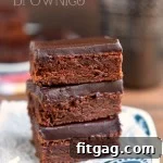 A stack of mocha truffle brownies on a blue and white plate.