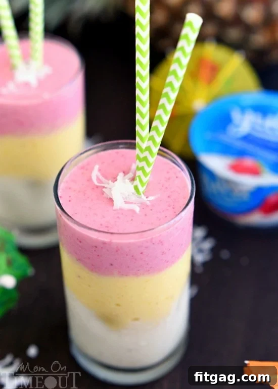 Sun-Kissed Paradise Smoothie 7 Two glasses of Tropical Sunrise Smoothie with straws, ready to be enjoyed as a refreshing healthy breakfast.
