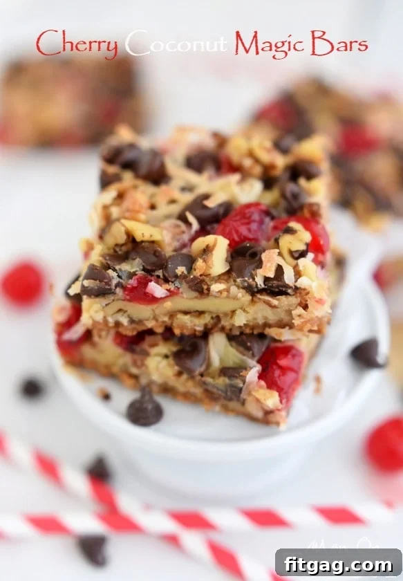 A stack of golden Cherry Coconut Magic Bars on a cooling rack, showcasing the perfect toastiness of the coconut and rich chocolate layers beneath. A simple yet decadent homemade dessert.