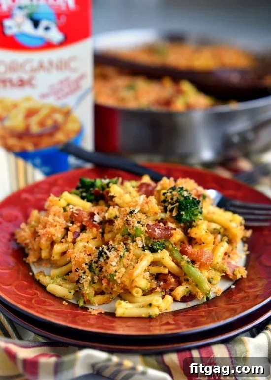 Overhead shot of Skillet Bacon and Broccoli Macaroni and Cheese in a cast iron skillet, with portions served in bowls.