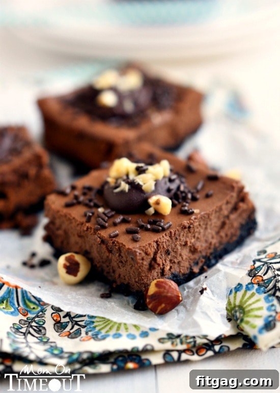 Nutella Cheesecake Squares 4 Perfectly baked Skinny Chocolate Hazelnut Cheesecake Bars, ready to be sliced, showcasing the rich texture and delicious toppings.