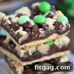 3 stacked chocolate mint fudge bars with green candies.