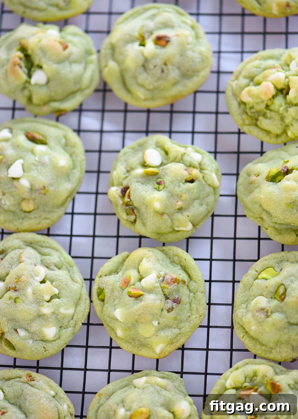 Velvety Pistachio Pudding Cookies 3 Top-down view of freshly baked pistachio pudding cookies cooling on a wire rack.