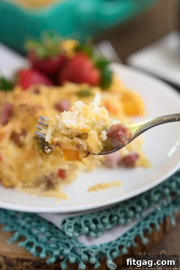 Golden Ham Cheese and Hash Brown Breakfast Delight 5 A vibrant, close-up shot of the ham, cheese, and hashbrown breakfast casserole, highlighting the colorful bell peppers and golden crust.