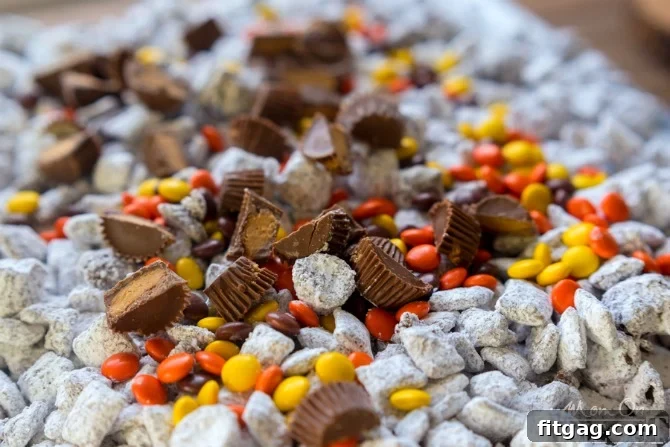 Adding halved Reese's Miniatures to the Muddy Buddies for an extra layer of peanut butter and chocolate goodness.