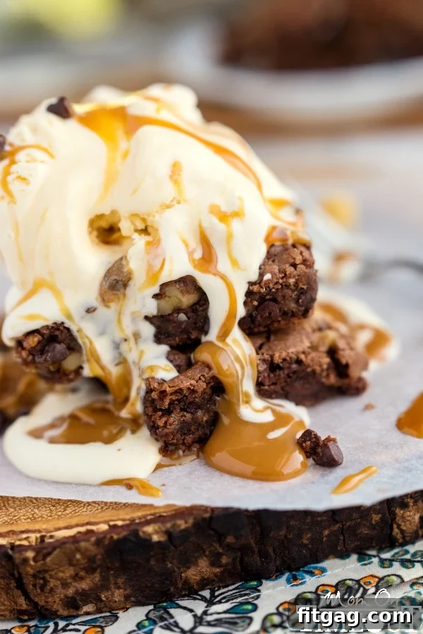 Scoops of ice cream with caramel sauce on a German Chocolate Caramel Brownie