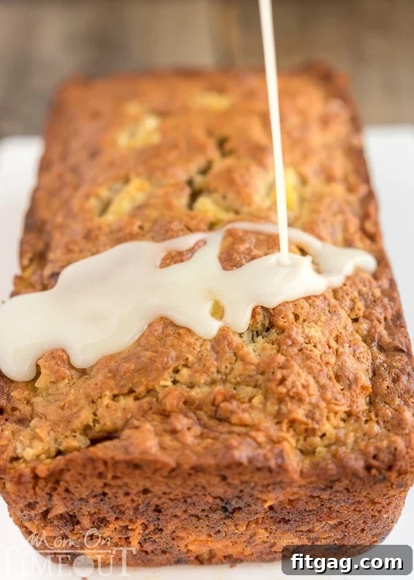 Moist slice of Pina Colada Banana Bread showing pineapple and coconut pieces