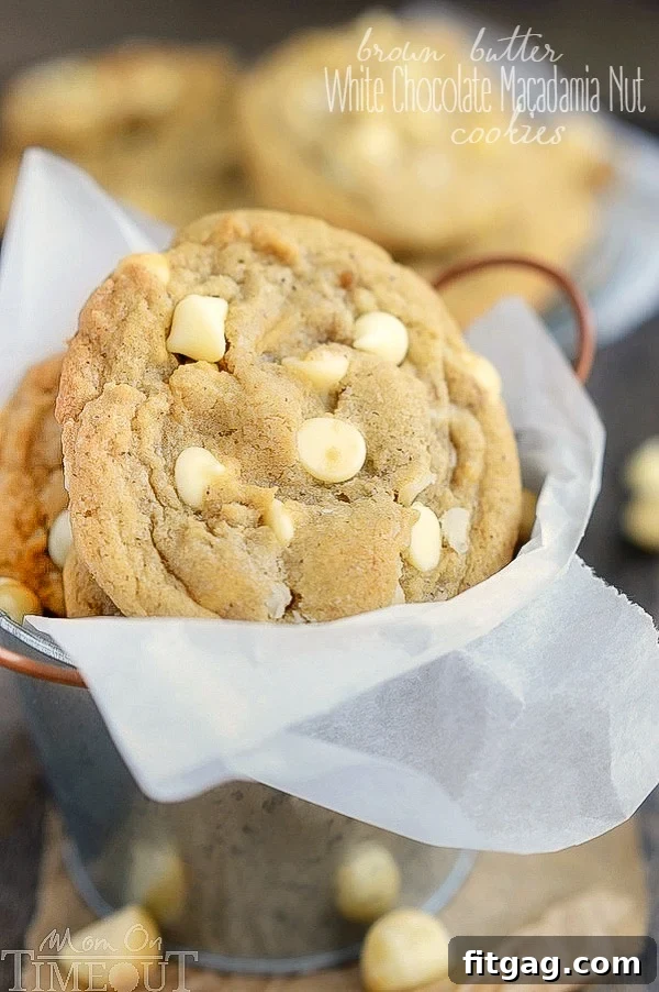 These insanely delicious Brown Butter White Chocolate Macadamia Nut Cookies are guaranteed to be a new favorite! Super easy to make and mouth watering good! This easy cookie recipe is one you will find yourself making over and over...| MomOnTimeout.com