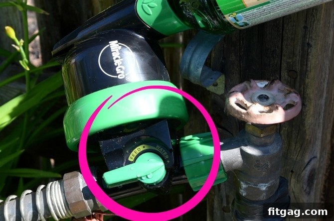 A close-up view of the Miracle-Gro LiquaFeed Universal Feeder, highlighting the simple switch mechanism that allows gardeners to effortlessly toggle between 'feed' and 'water' functions for convenient plant nourishment.