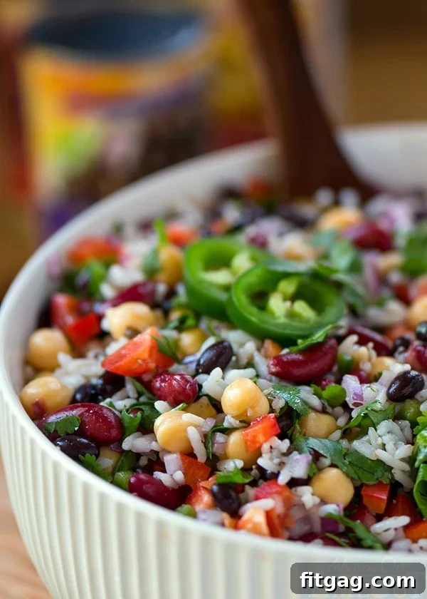 A close-up shot of the finished Wild Rice Three Bean Salad, showcasing the colorful beans, vegetables, and wild rice coated in a light dressing