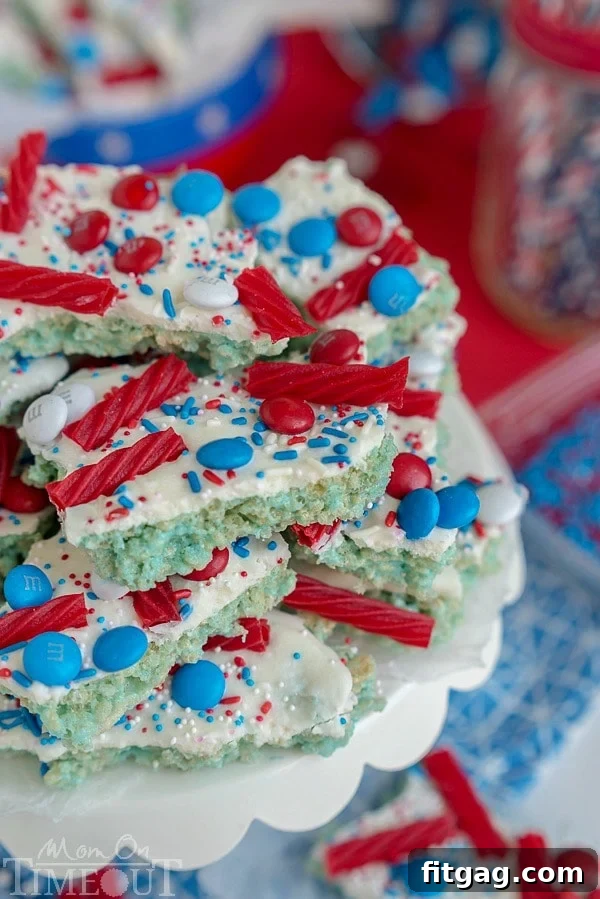 Close-up of freshly made Red White and Blue Rice Krispies Treats Bark, showcasing its vibrant layers and candy toppings.