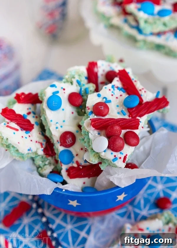 Red White and Blue Rice Krispies Treats Bark squares arranged on a platter, ready to serve as a festive treat.