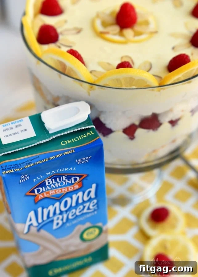 Airy Lemon Raspberry Cheesecake Trifle 5 A step-by-step image of layering the ingredients for the Skinny Lemon Raspberry Cheesecake Trifle